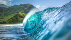 Ocean wave with mountains in the background