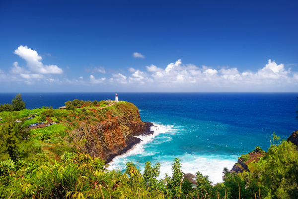 Kauai mountains with lighthouse and ocean in the background
