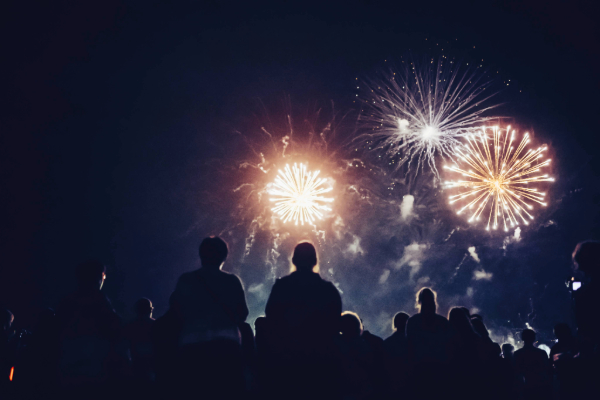 fireworks at night with people watching