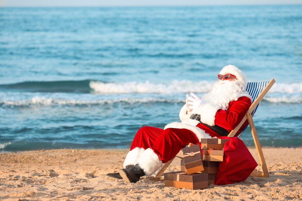 Happy Santa Claus with gifts at sea resort