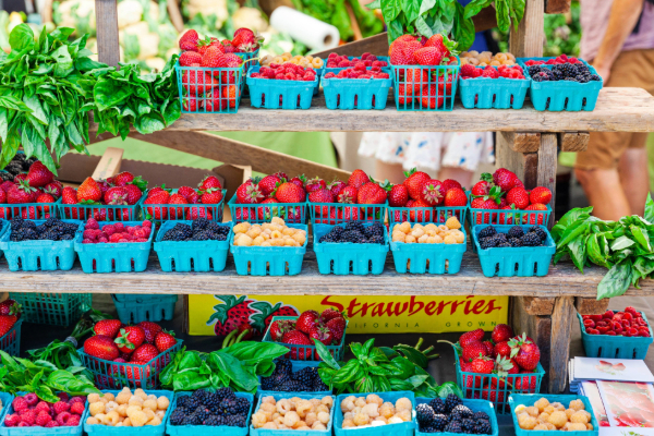 berries in containers at outdoor market