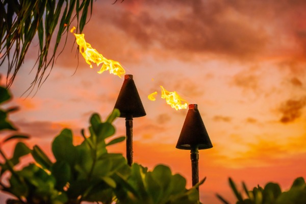 luau at sunset with fire in the tiki torches